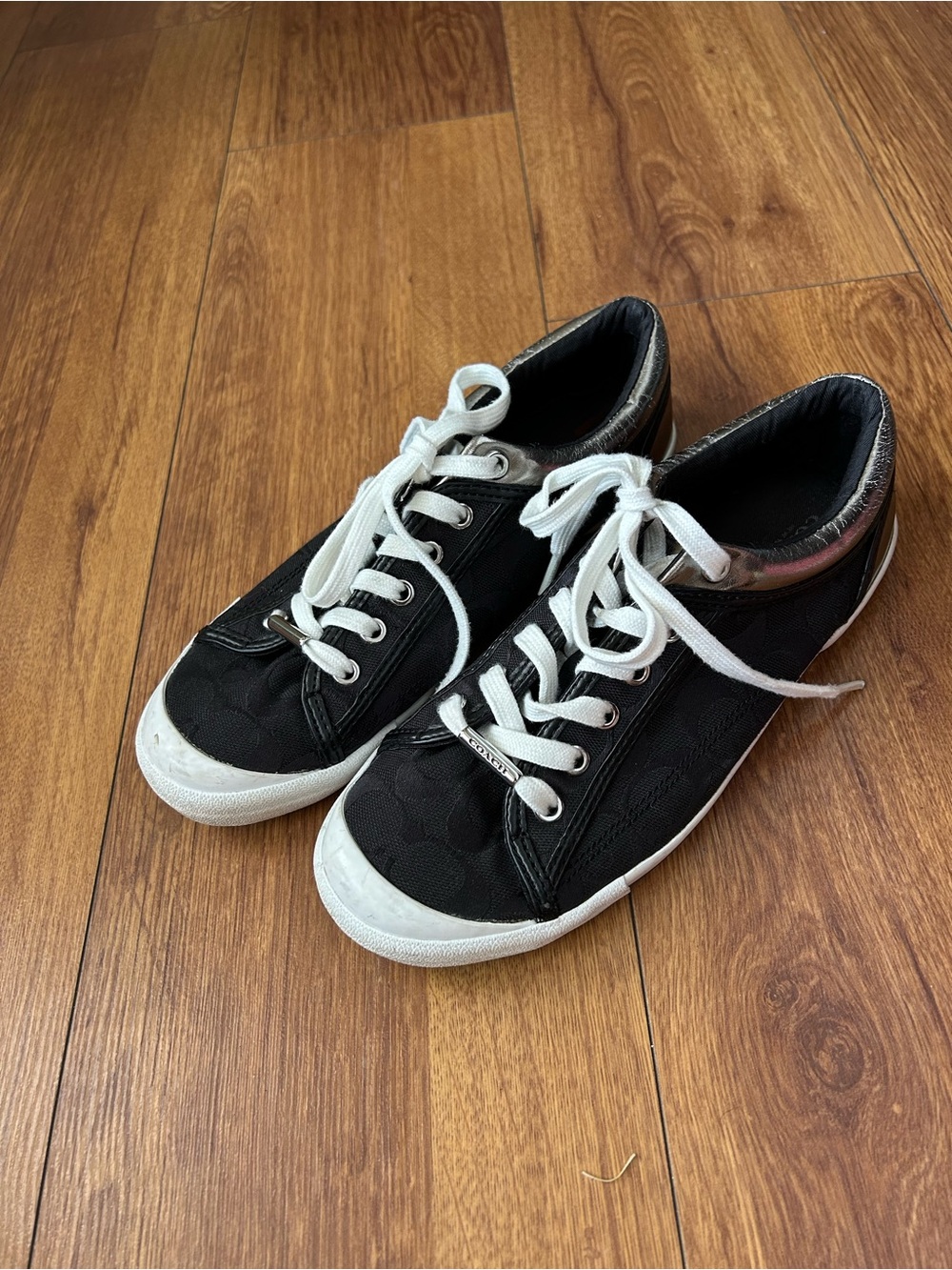 Coach Black Low-Top Sneakers with White Accents and Metallic Heel